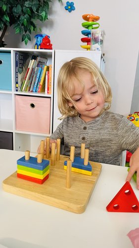 Child doing Montessori stacking activity
