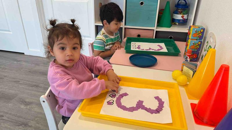 Two kids doing number and letter activities
