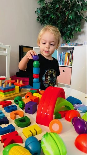 Child stacking colourful blocks