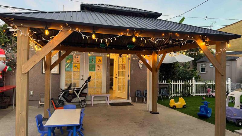Backyard gazebo with fairy lights at dusk