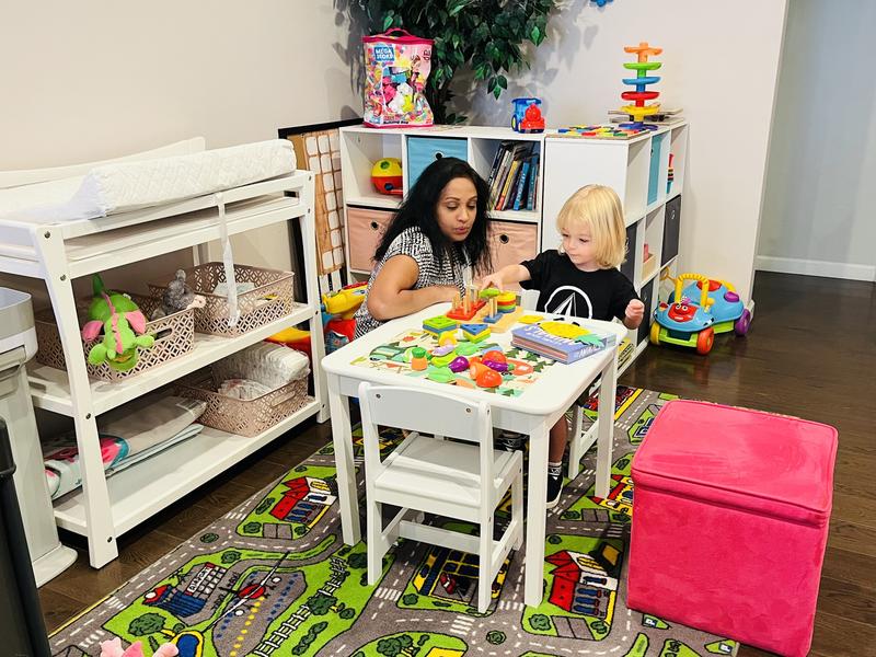 Ms. Umanga playing with a child at Nice Time Daycare